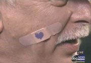 Delegate wearing band-aid on face